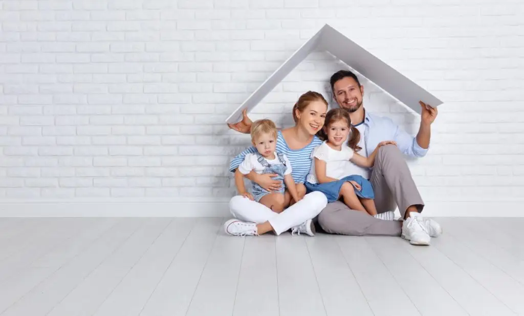 concept housing a young family. mother father and children in new home
